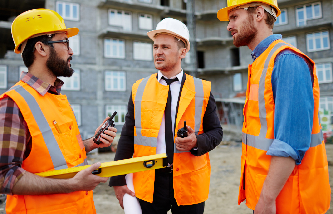 Site manager and engineers with a tablet on a construction site
