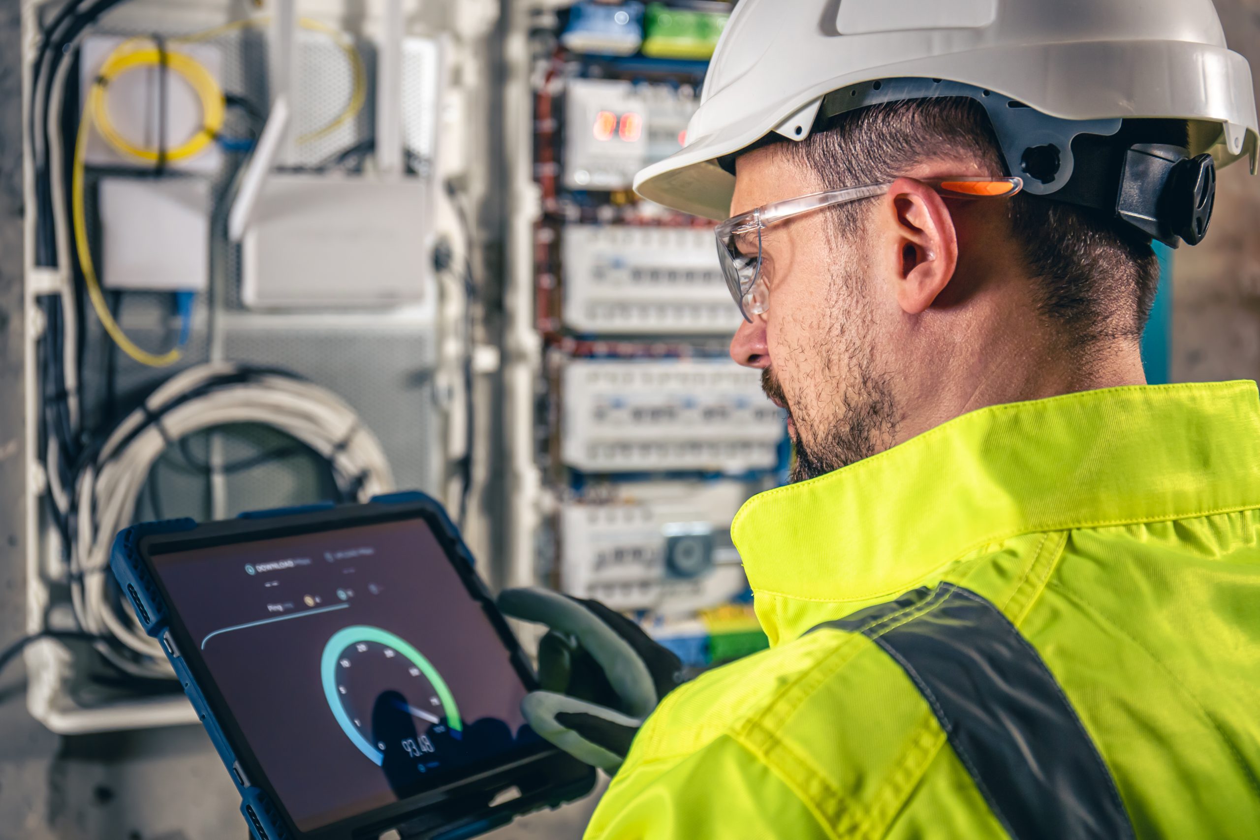 Service technician checking a switchboard with a tablet