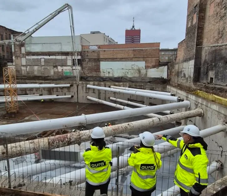 Engineers in high-visibility vests on a construction site